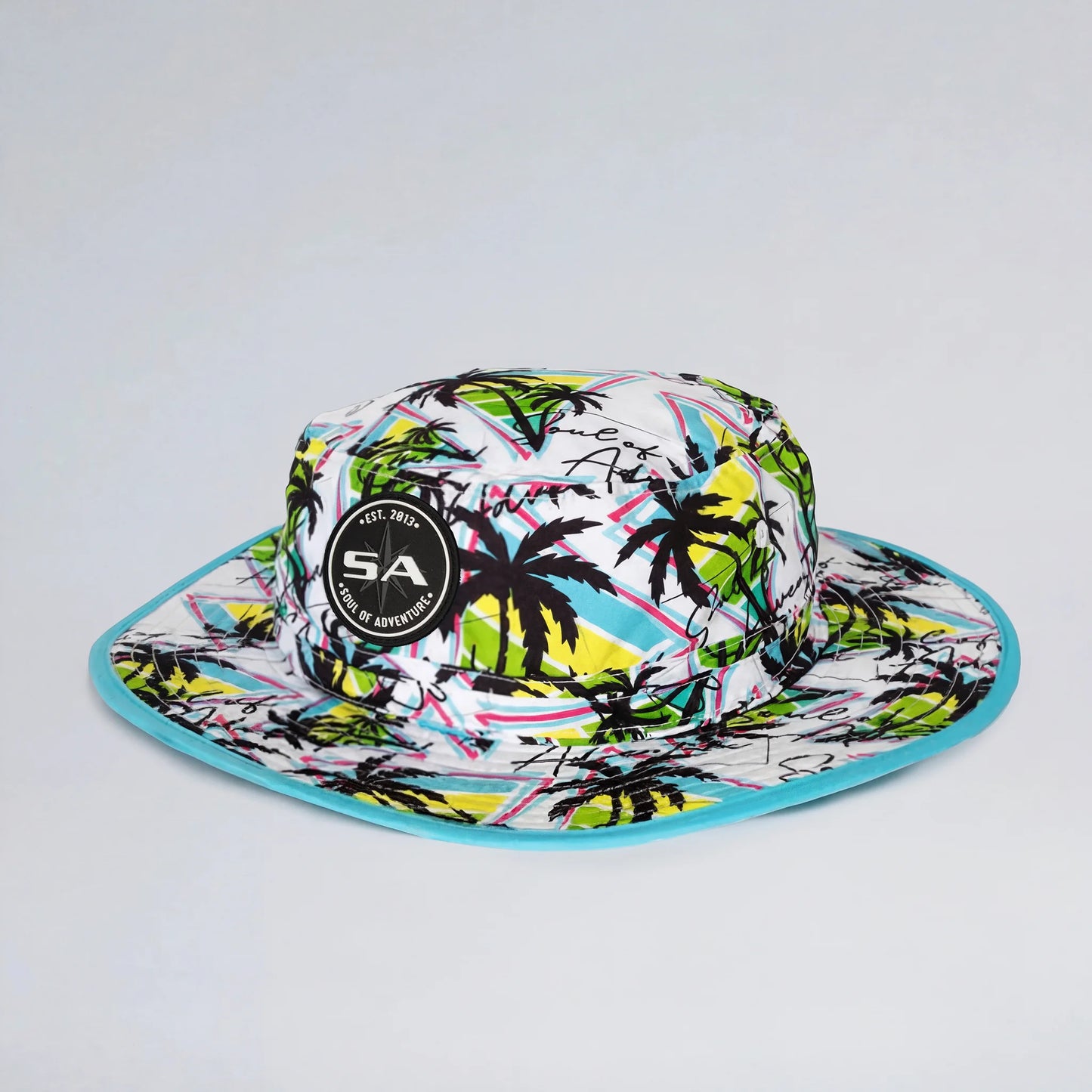 Colorful bucket hat with palm tree design on a white background