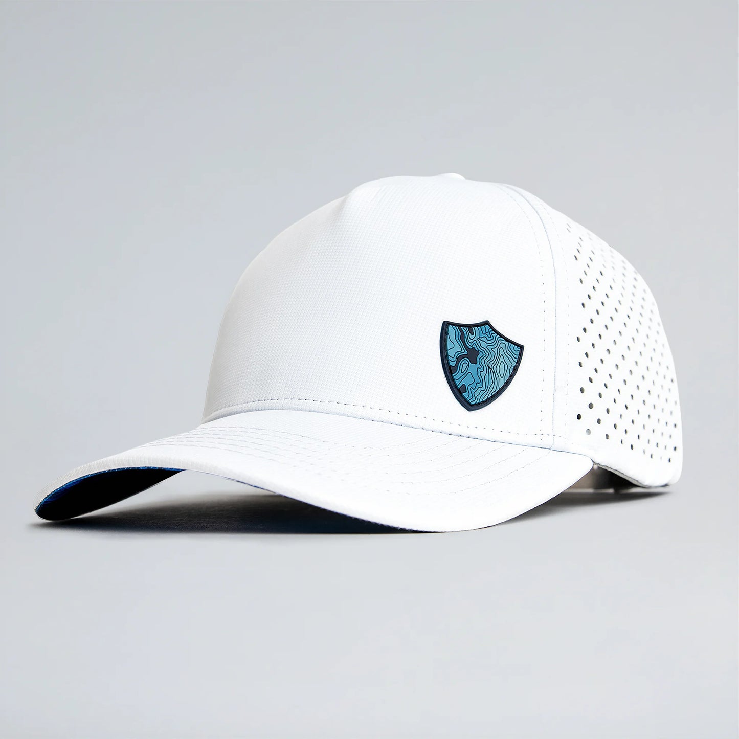 White baseball cap with a blue logo on a gray background