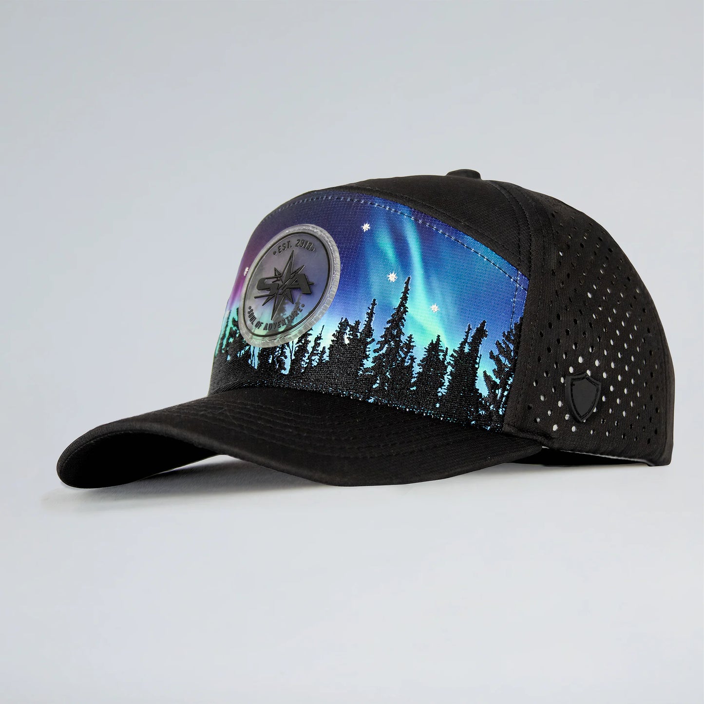 Black cap with Northern Lights design on a light gray background