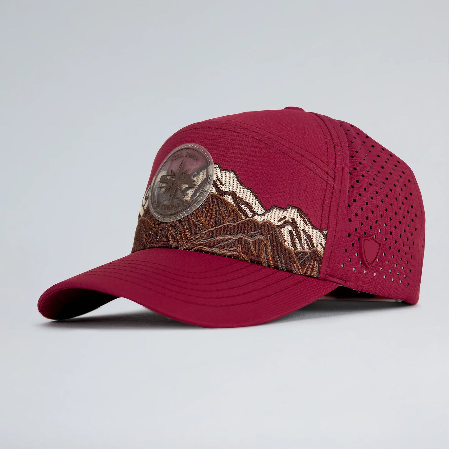 Red cap with mountain design on a light gray background