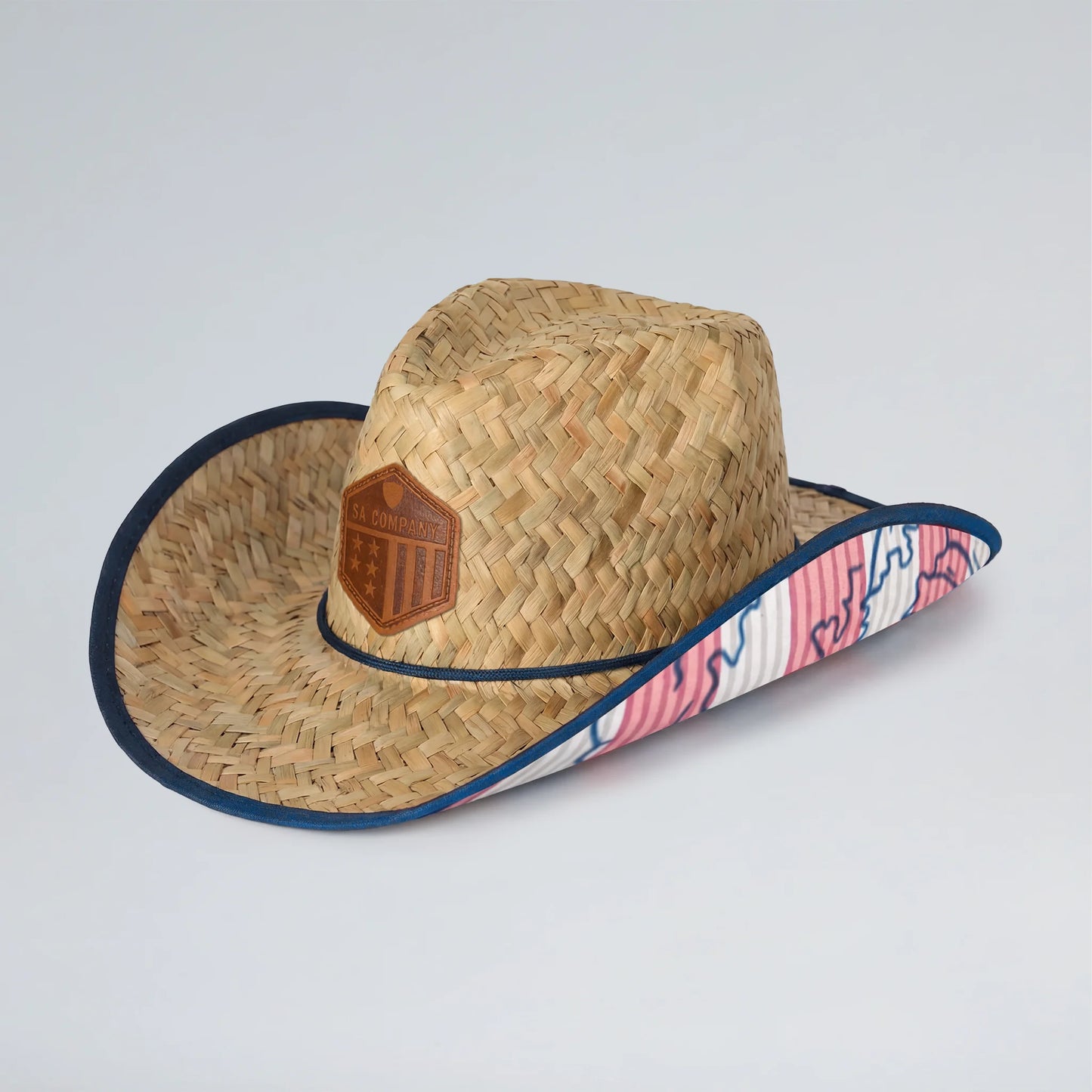 Straw hat with a decorative band on a light gray background