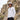 Man wearing a white bucket hat and UV long sleeve standing in front of rocky cliffs.