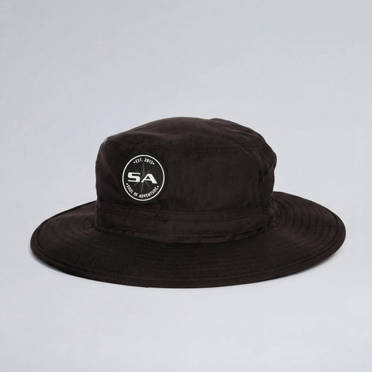 Black bucket hat with a logo on a light gray background