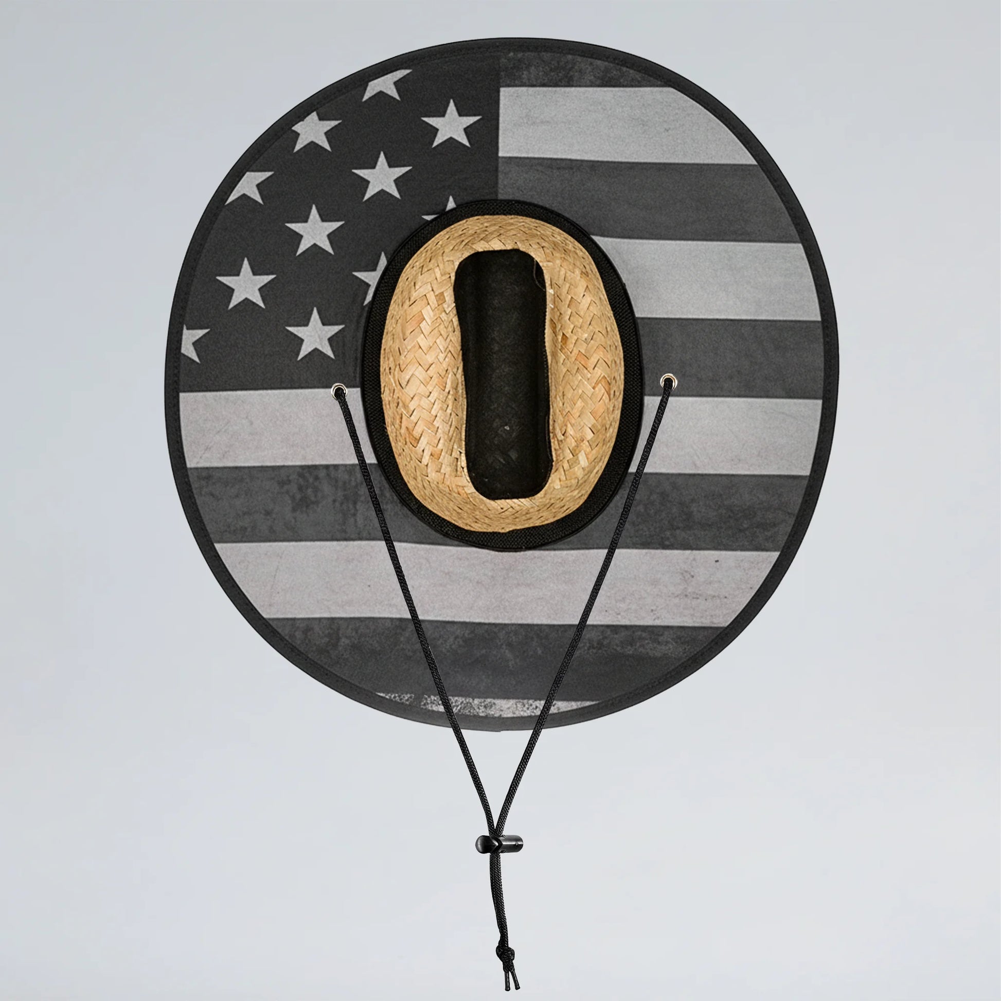 Round hat rack with American flag design holding a straw cowboy hat on a light gray background