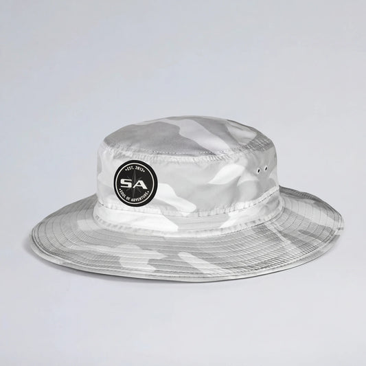 Clear camouflage bucket hat with a logo on a light gray background