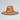 Straw hat with a USA flag patch on a light gray background