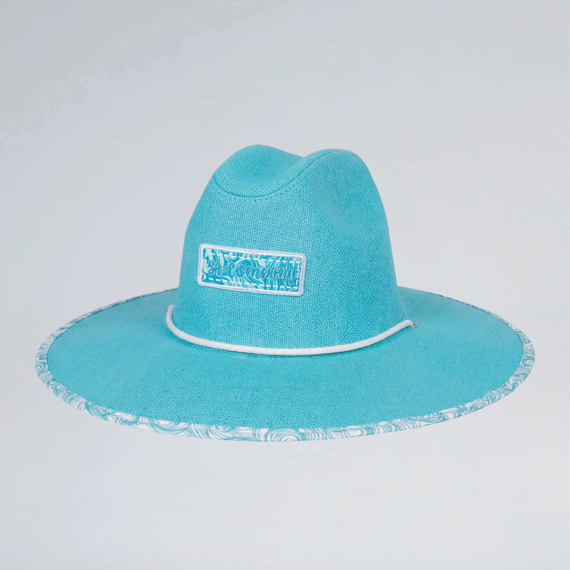 Turquoise wide-brimmed hat with a logo on a light gray background