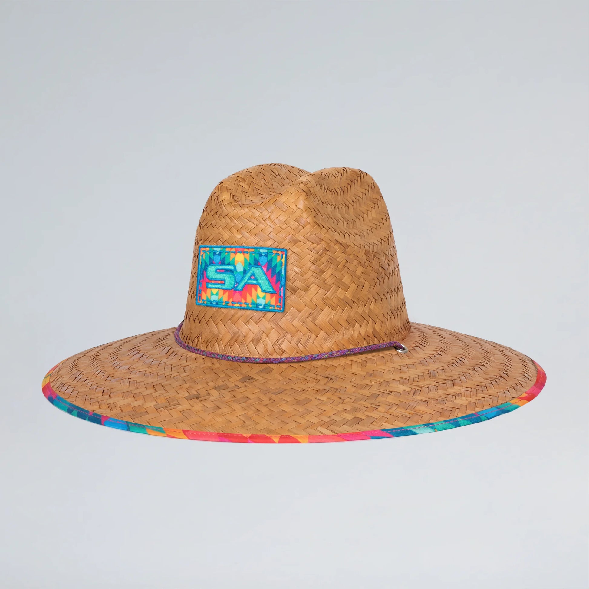 Straw hat with a colorful patch on a light gray background