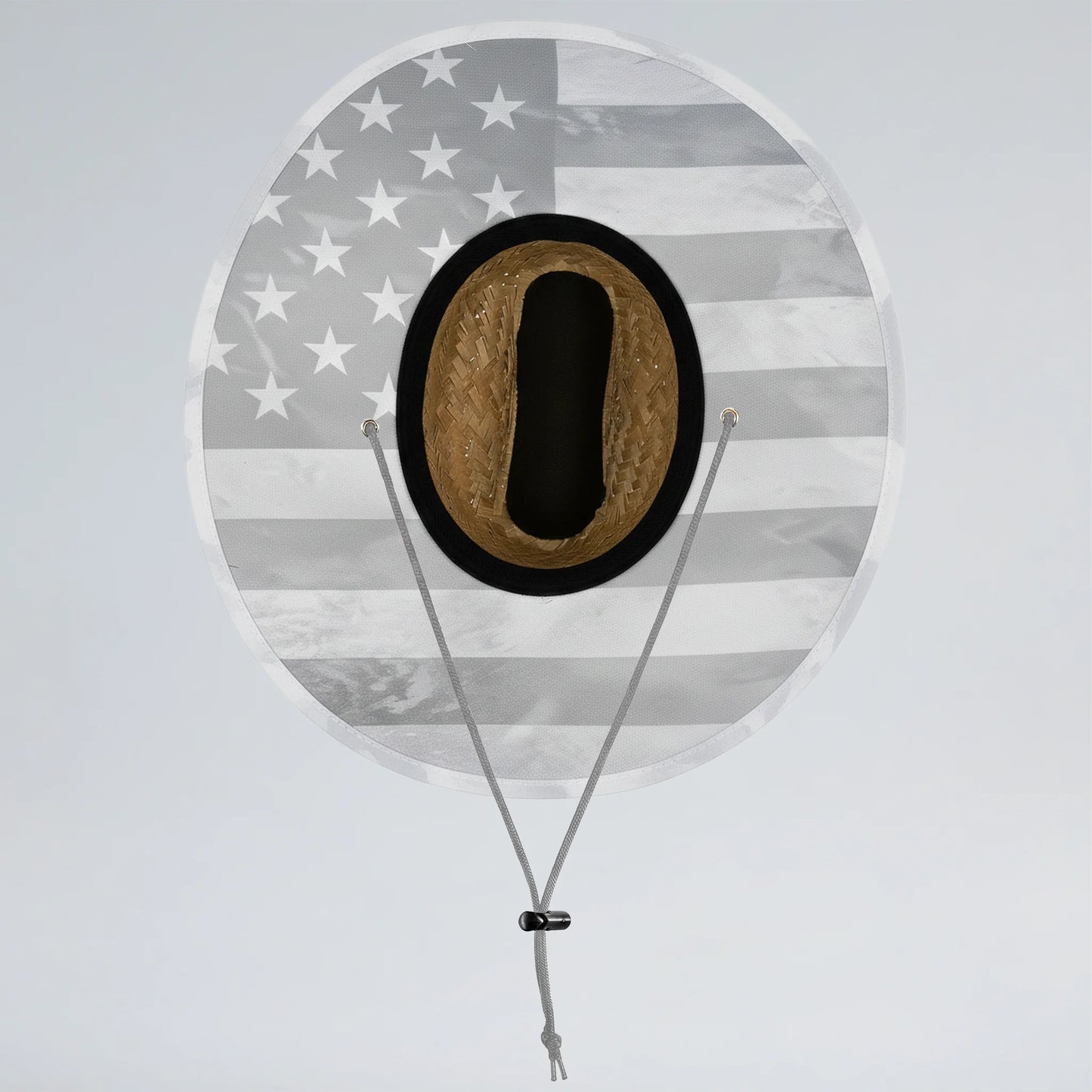 Round sign with American flag pattern and a black circle containing a brown object, on a light gray background.