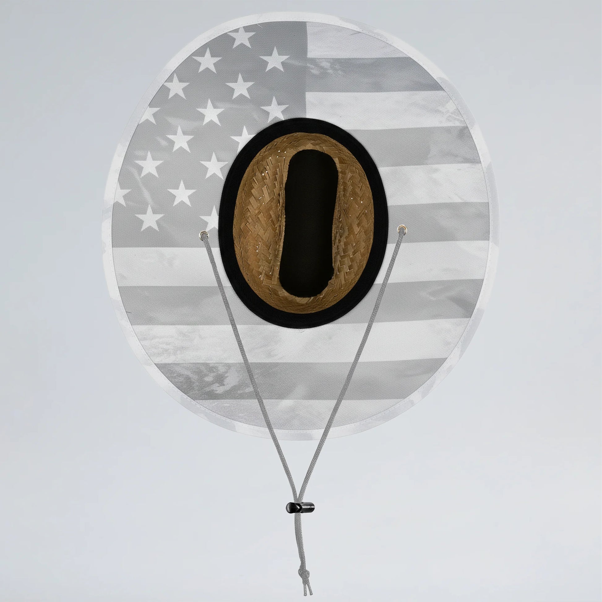 Round sign with American flag pattern and a black circle containing a brown object, on a light gray background.