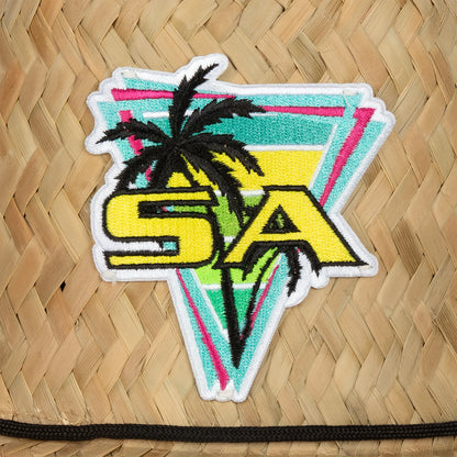 Colorful patch with 'SA' and palm tree design on a woven surface