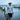 Man walking by dock wearing a white and grey american flag bucket hat