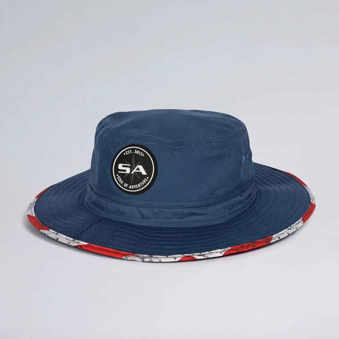 Navy blue bucket hat with colorful rim on a light gray background