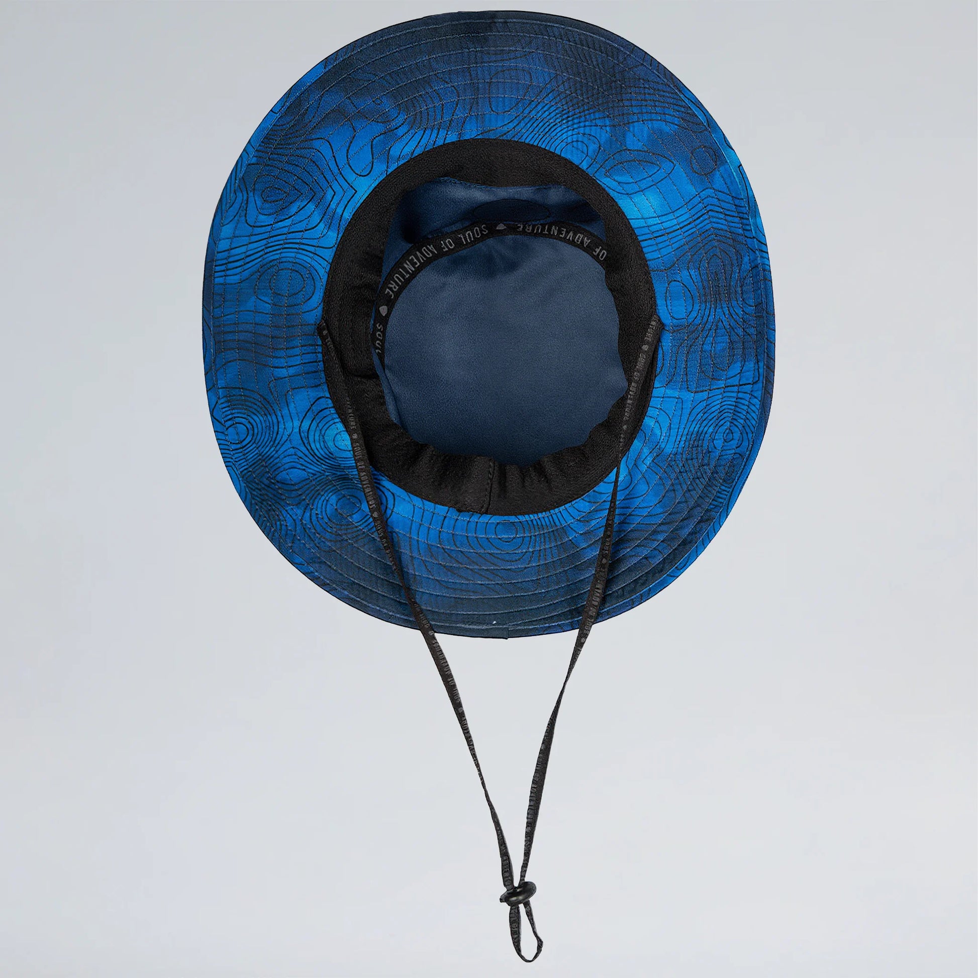 Blue patterned sun hat with black brim and chin strap on a light gray background