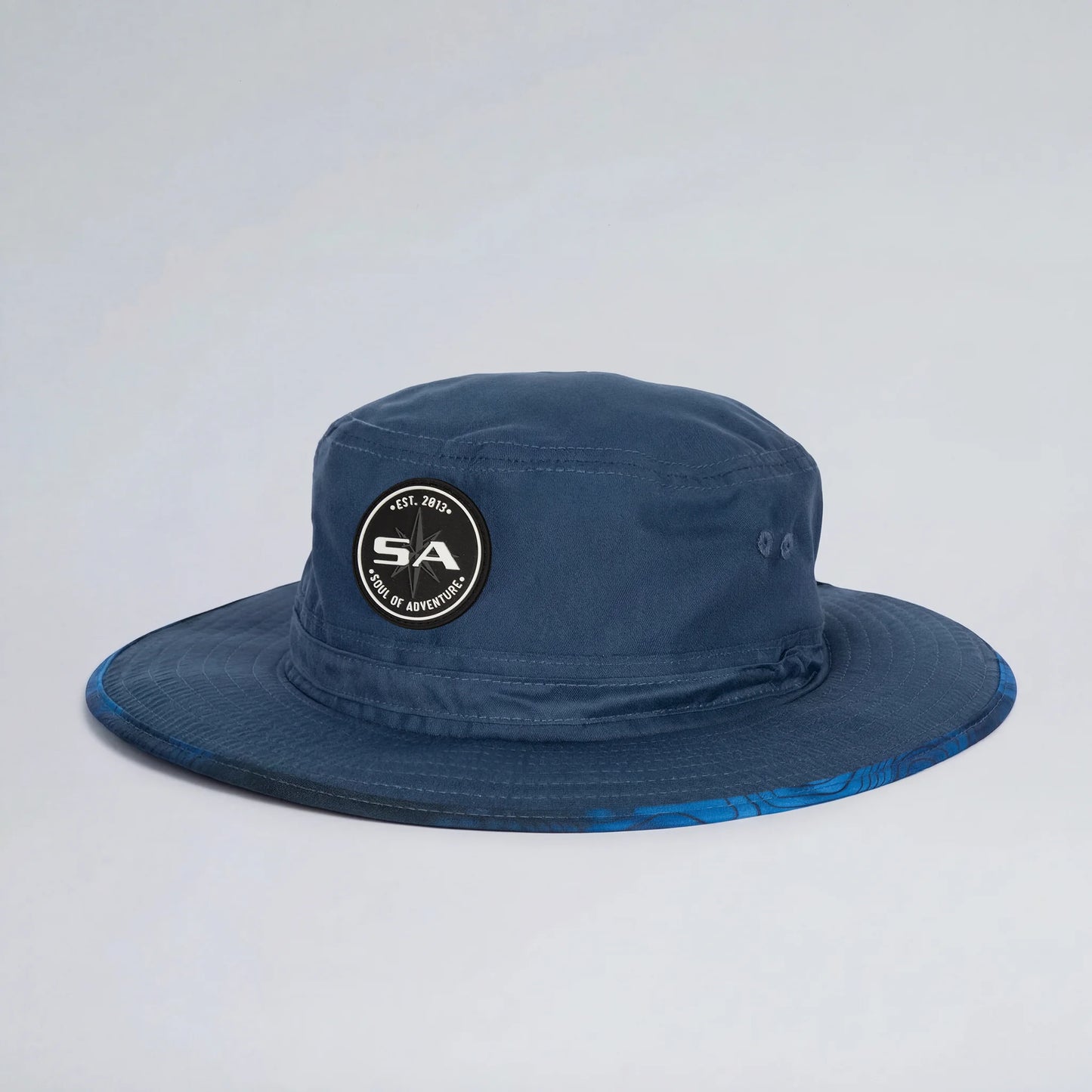 Blue bucket hat with a logo on a light gray background