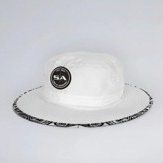 White bucket hat with black and white patterned brim on a light gray background