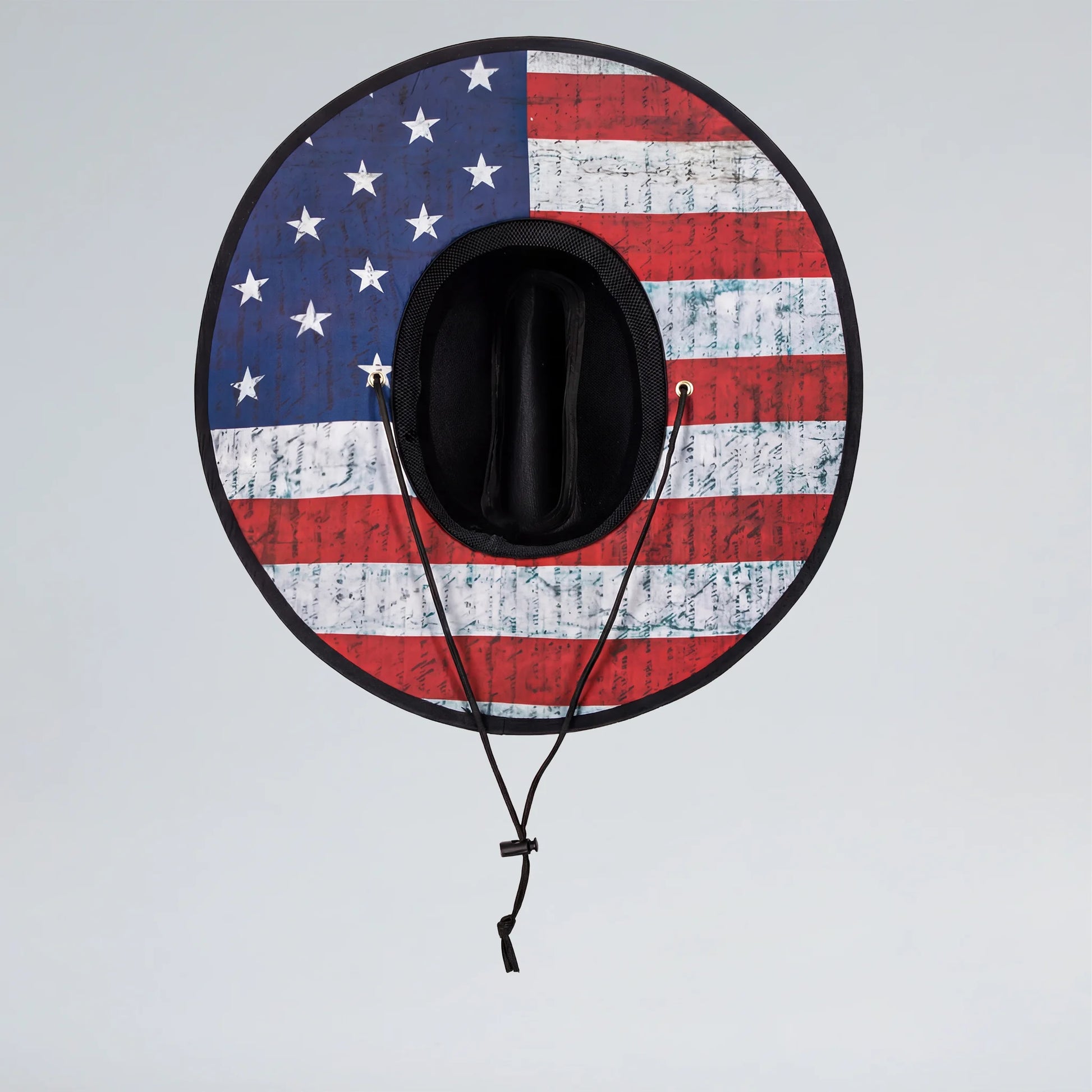 Black cowboy hat with American flag design on a light gray background