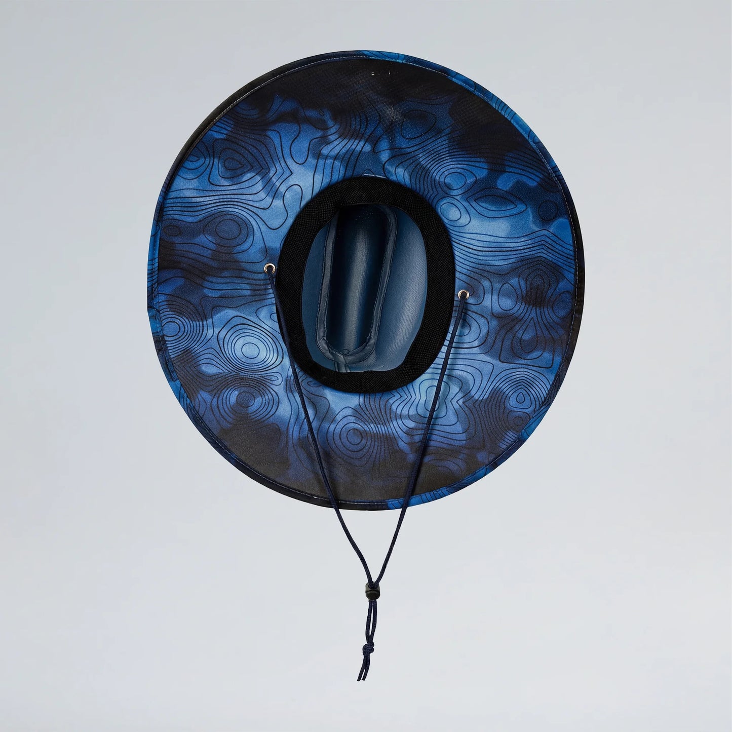 Blue and black patterned hat with a plain background