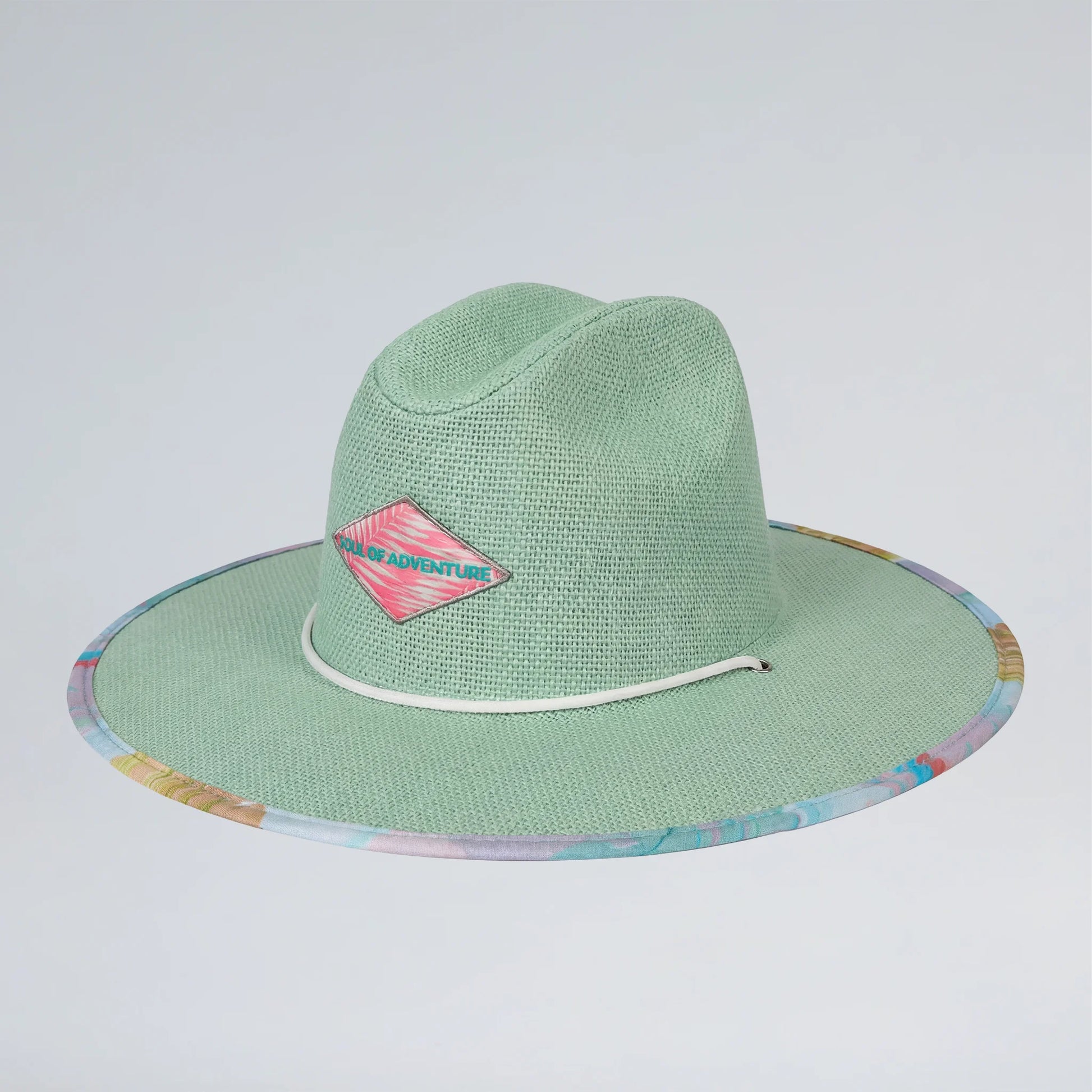 Green straw hat with colorful rim and pink logo on a light gray background