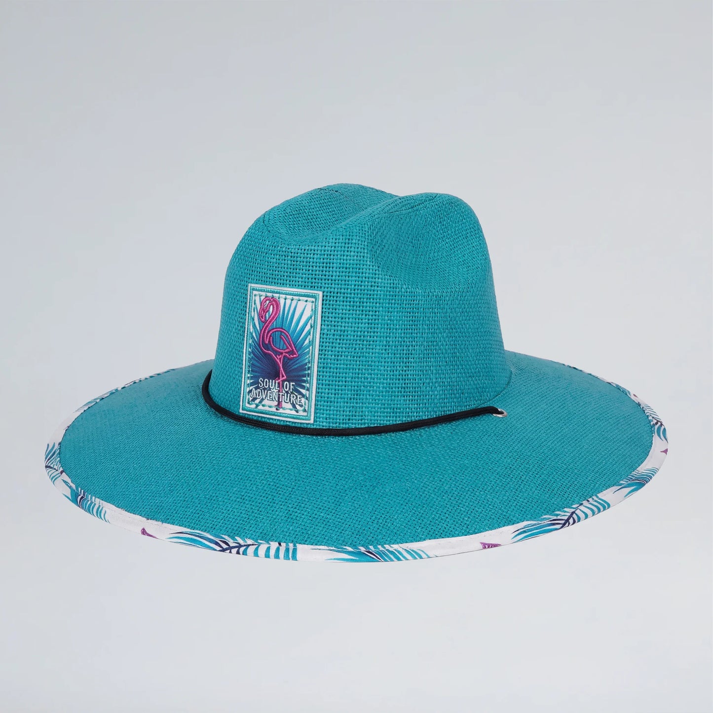 Teal straw hat with a flamingo emblem on a light blue background