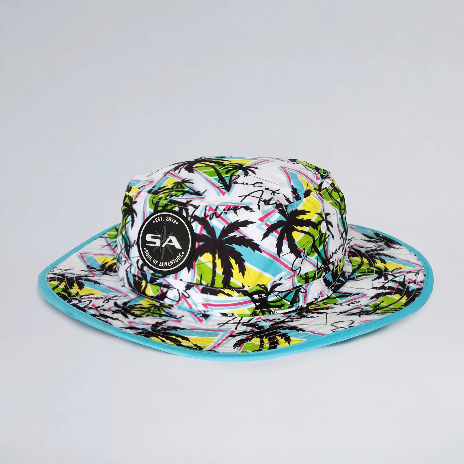Colorful bucket hat with palm tree design on a white background