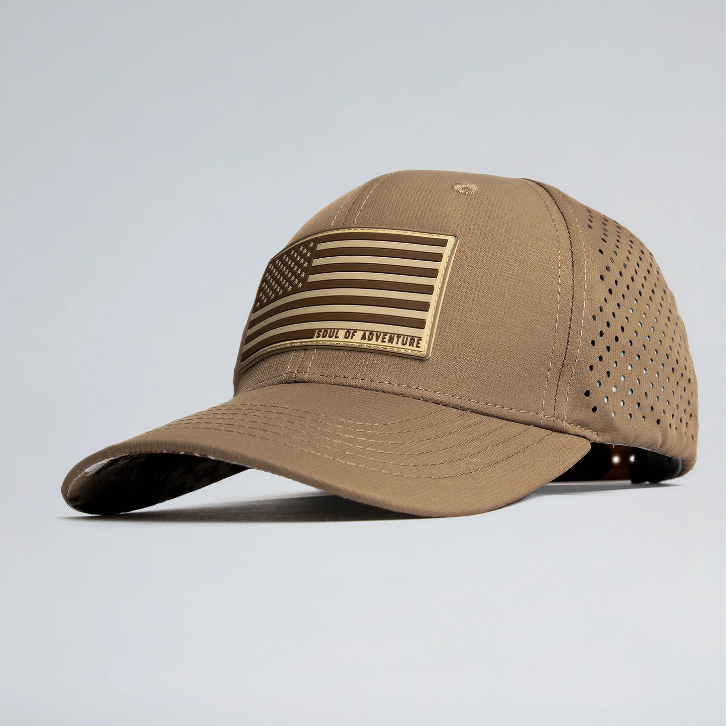 Tan baseball cap with American flag patch on a light gray background