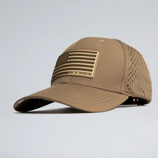 Tan baseball cap with American flag patch on a light gray background