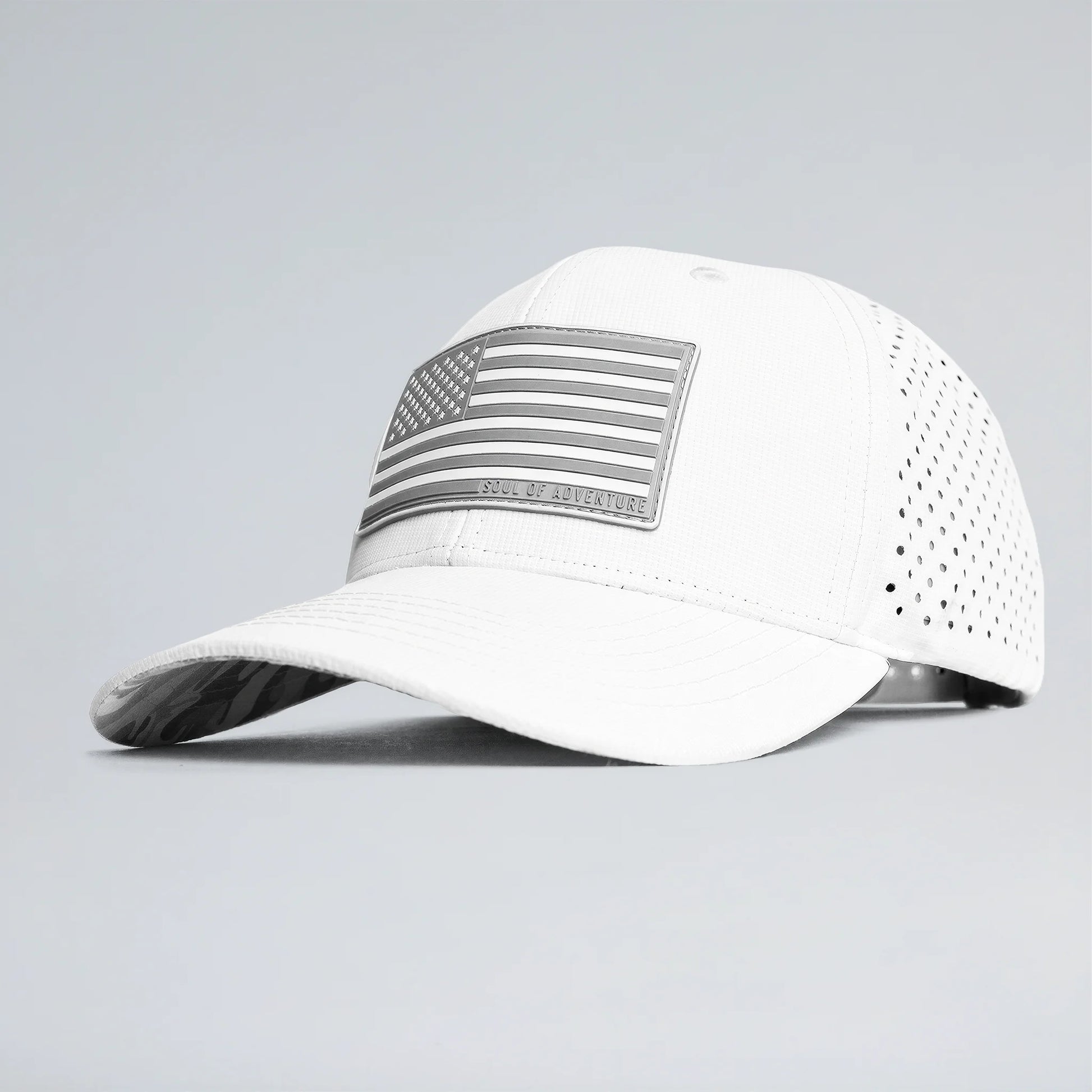 White baseball cap with an American flag patch on a gray background