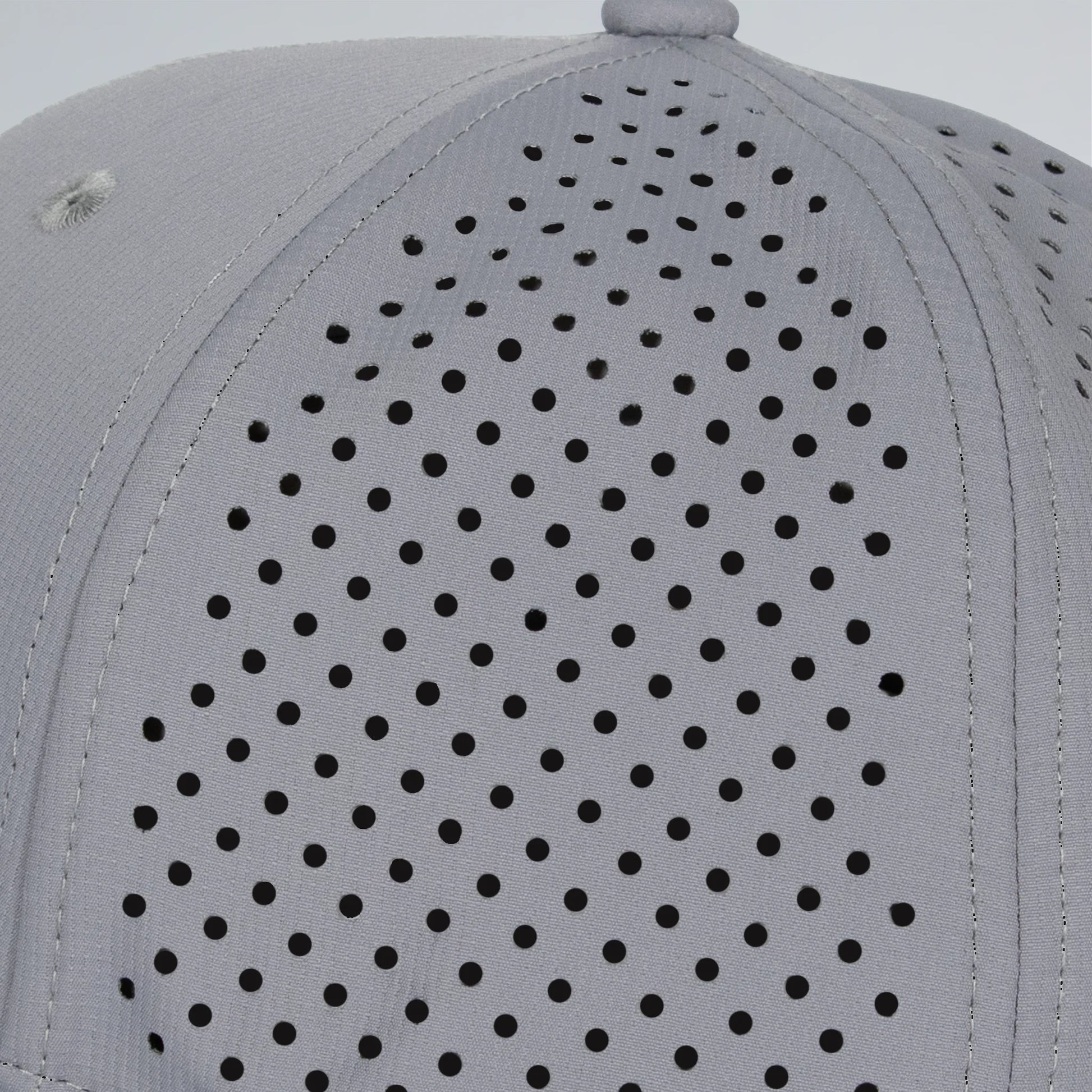 Gray cap with black perforated pattern on a light gray background
