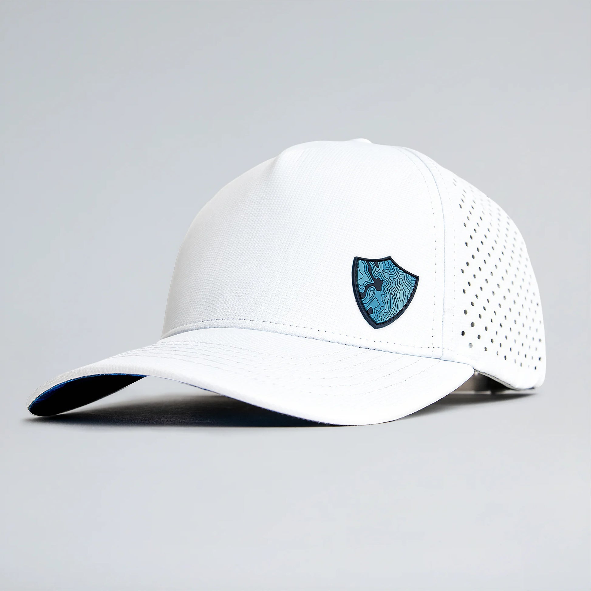 White baseball cap with a blue logo on a gray background