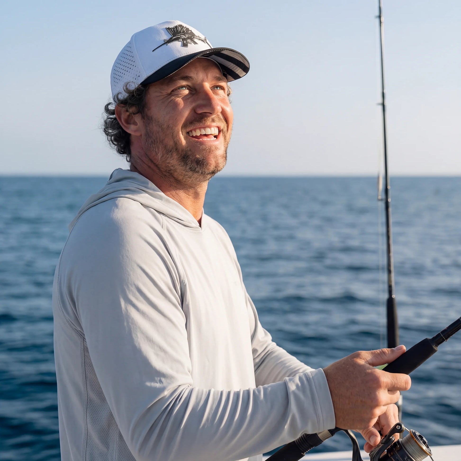 Man fishing on a boat with ocean in the background