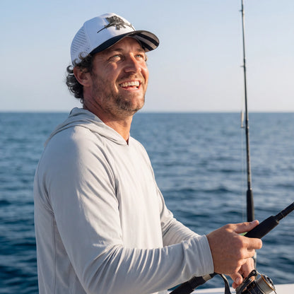 Man fishing on a boat with ocean in the background
