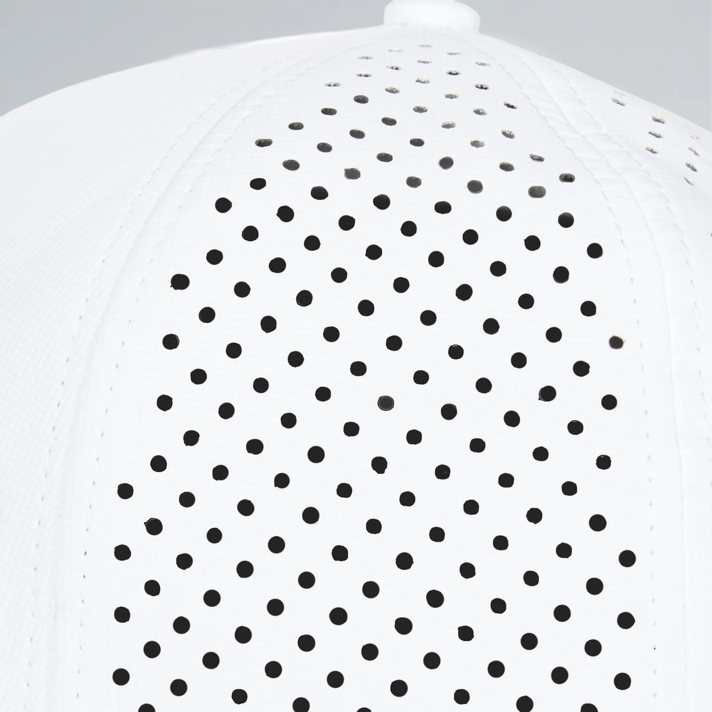 White shirt with black polka dot pattern on a light gray background
