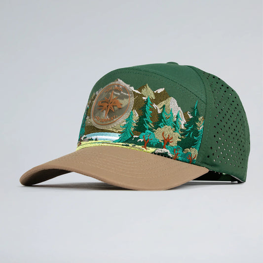 Green and brown cap with embroidered design on a light gray background