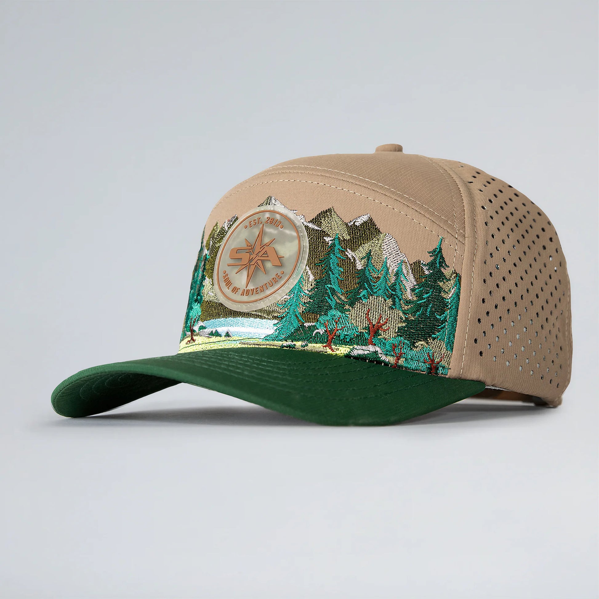 Beige and green cap with nature-themed design on a light gray background