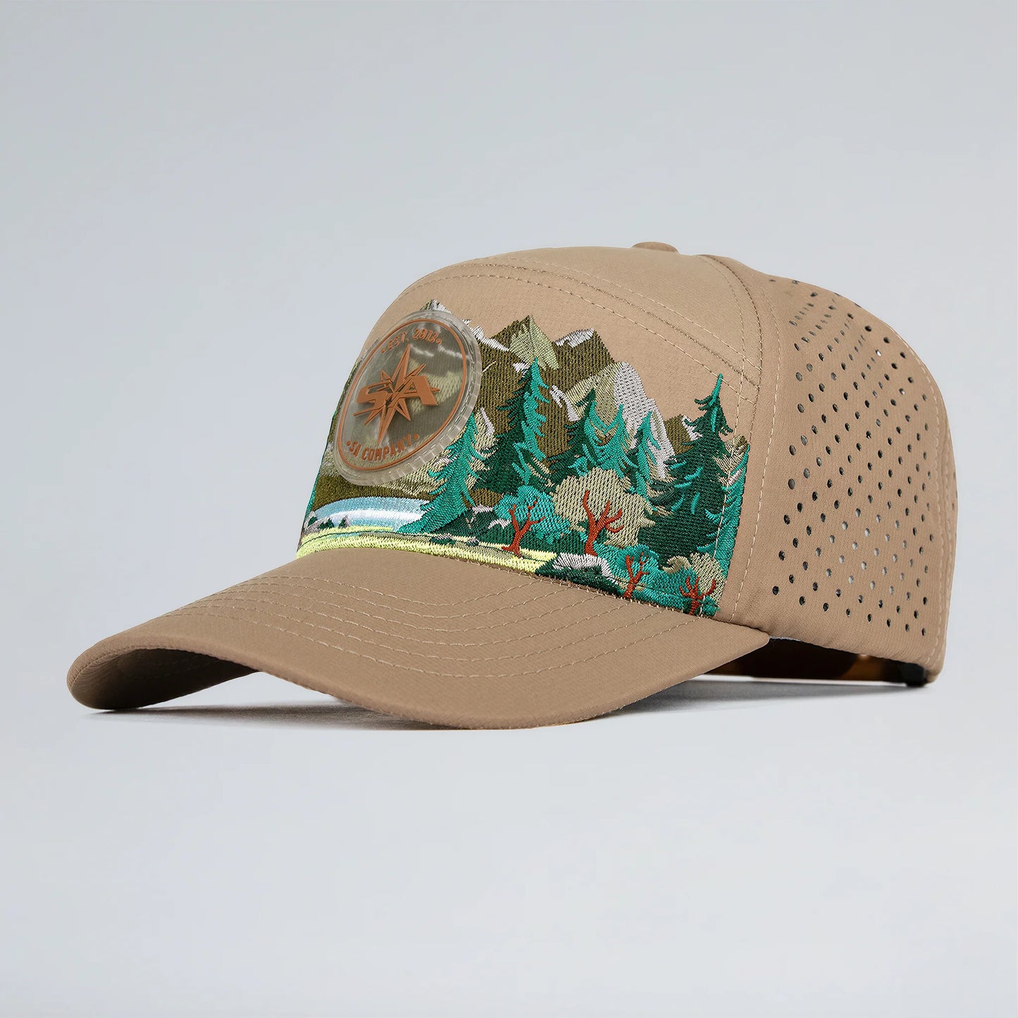 Beige cap with nature-themed design on a light gray background