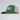 Green and beige baseball cap with a logo on a light gray background