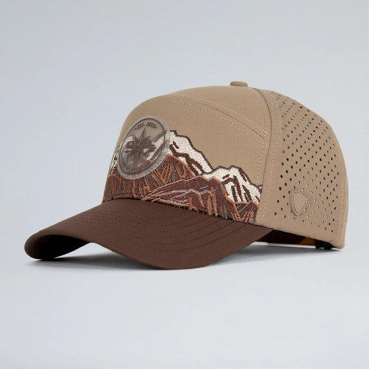 Brown and beige baseball cap with mountain design on a light gray background