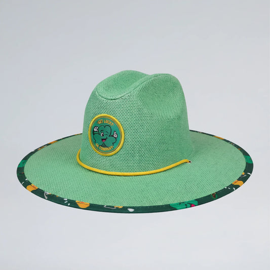 Green straw hat with a circular emblem on a light gray background