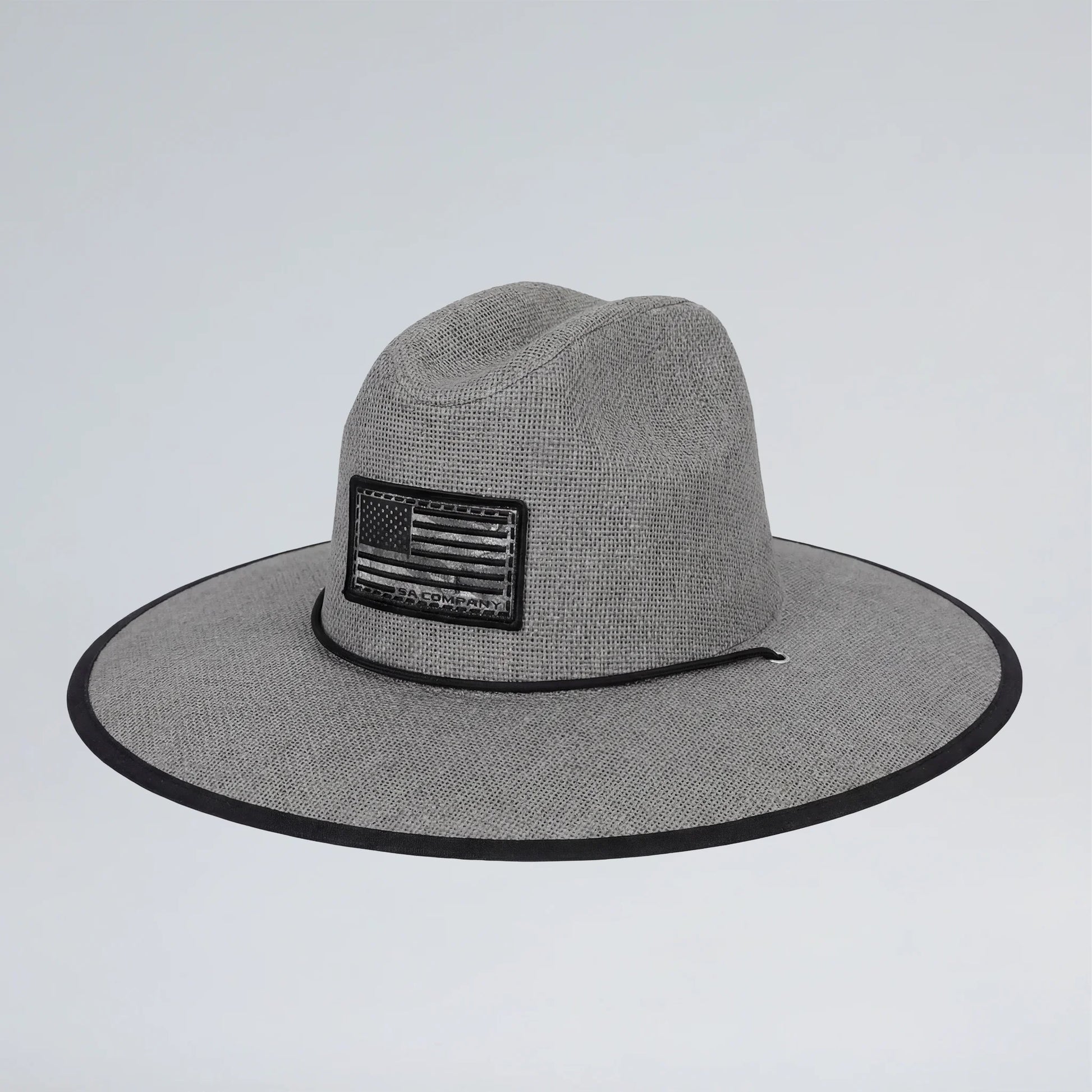 Gray wide-brimmed hat with an American flag patch on a light gray background