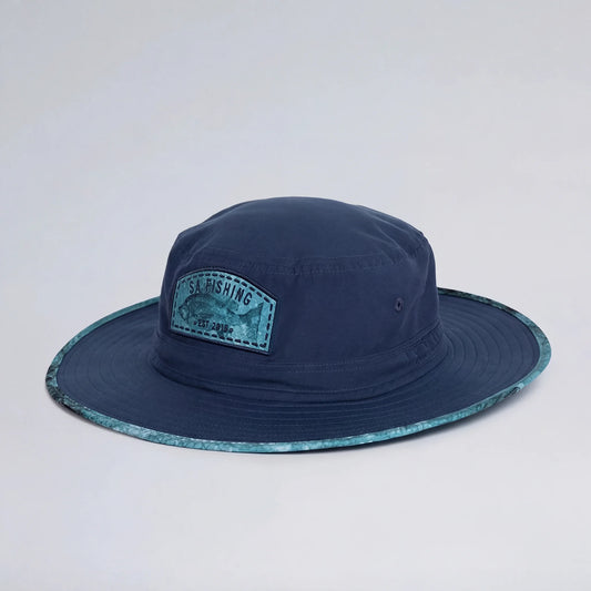 Navy blue fishing hat with a patch on a light gray background