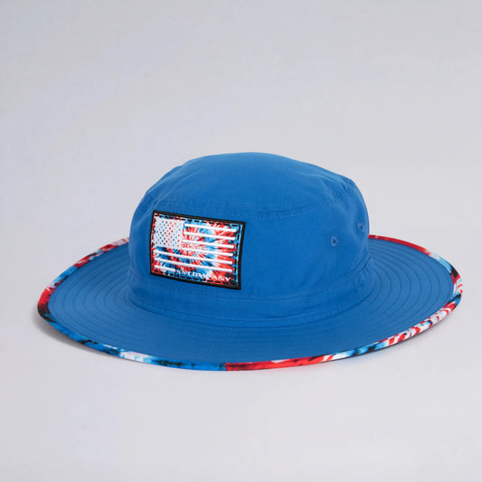 Blue bucket hat with American flag patch on a light gray background