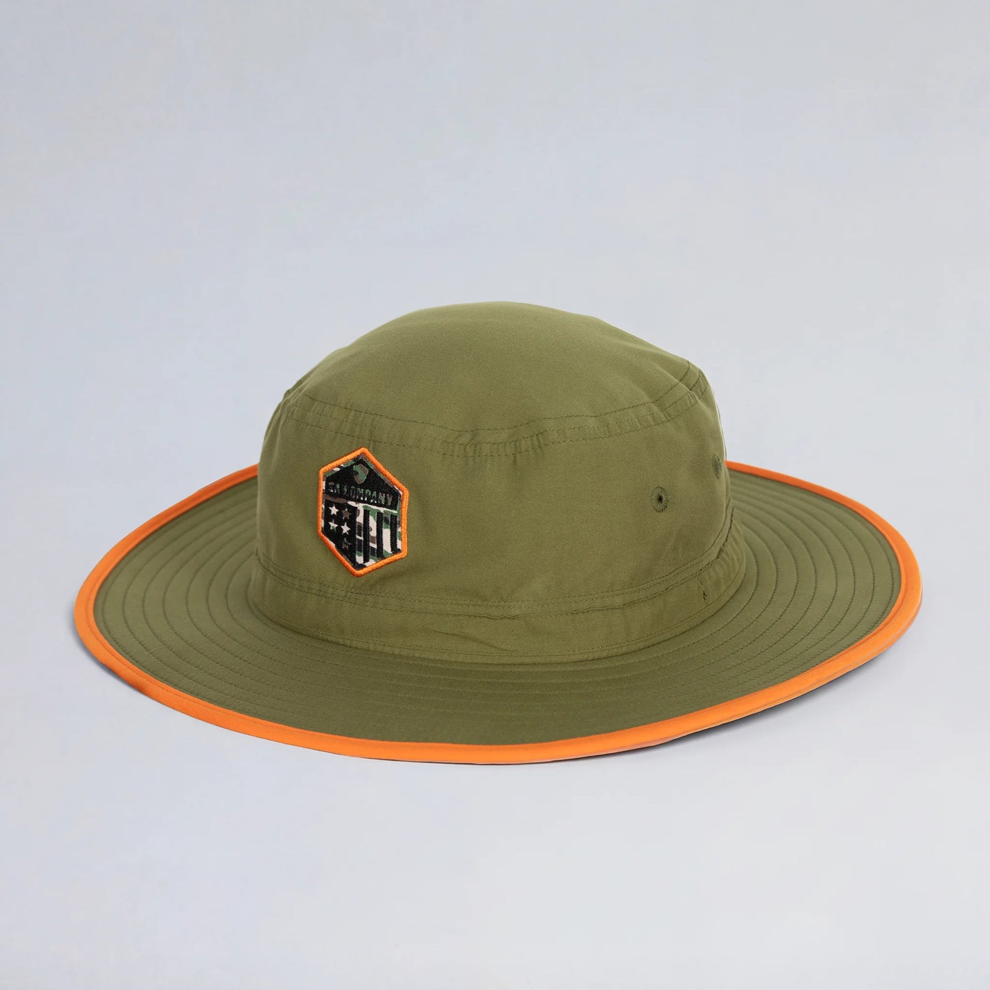 Green bucket hat with orange rim on a light gray background