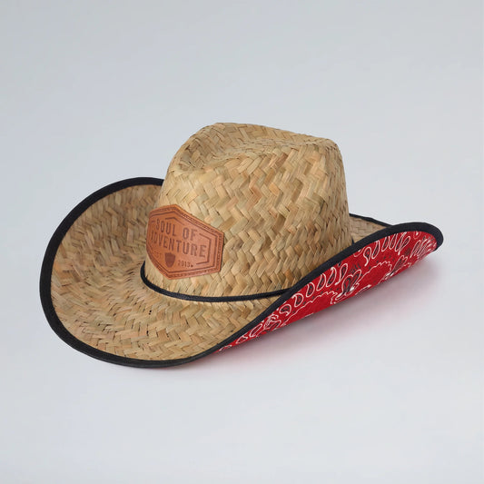Straw cowboy hat with red bandana and leather patch on a white background
